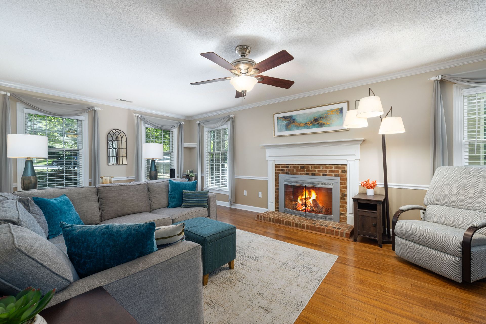 Inviting living room featuring a cozy fireplace, modern furniture, and bright natural lighting.